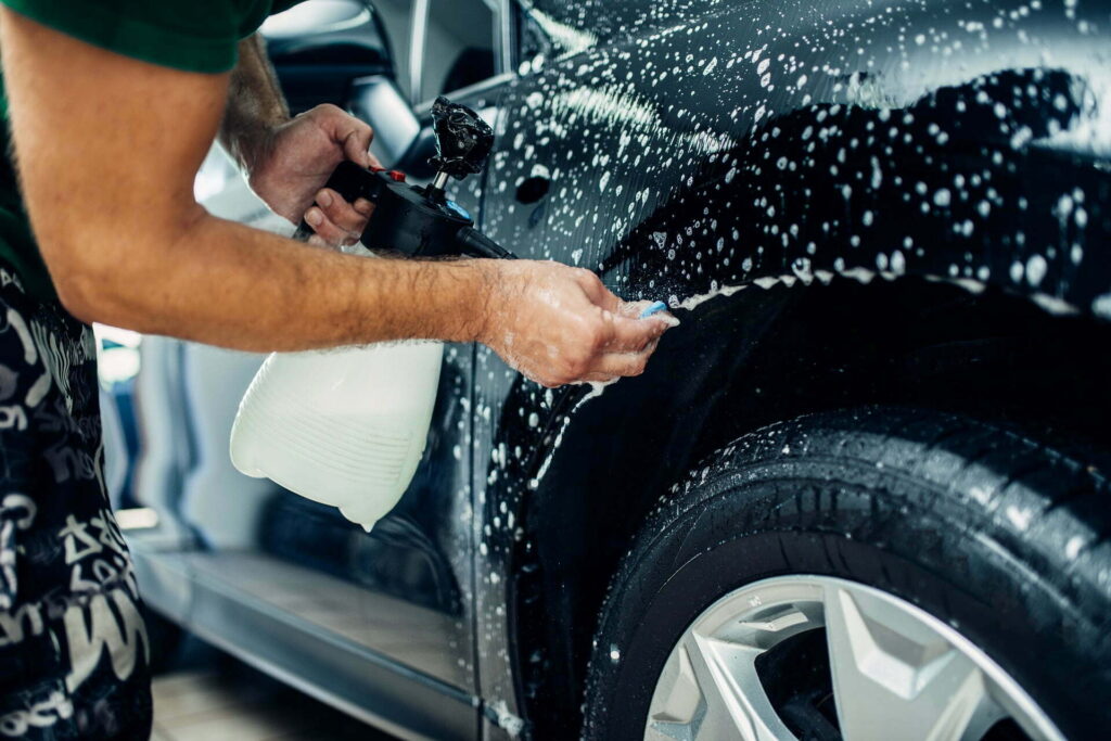 worker disperses soapy water in mobile exterior detailing process at Luxe Detailing Pro in Anaheim CA